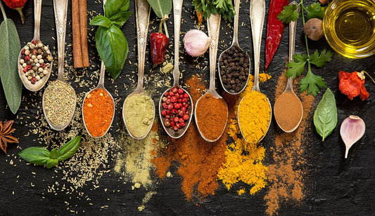 A topdown shot of multiple spoons with various spices and mushrooms in them.