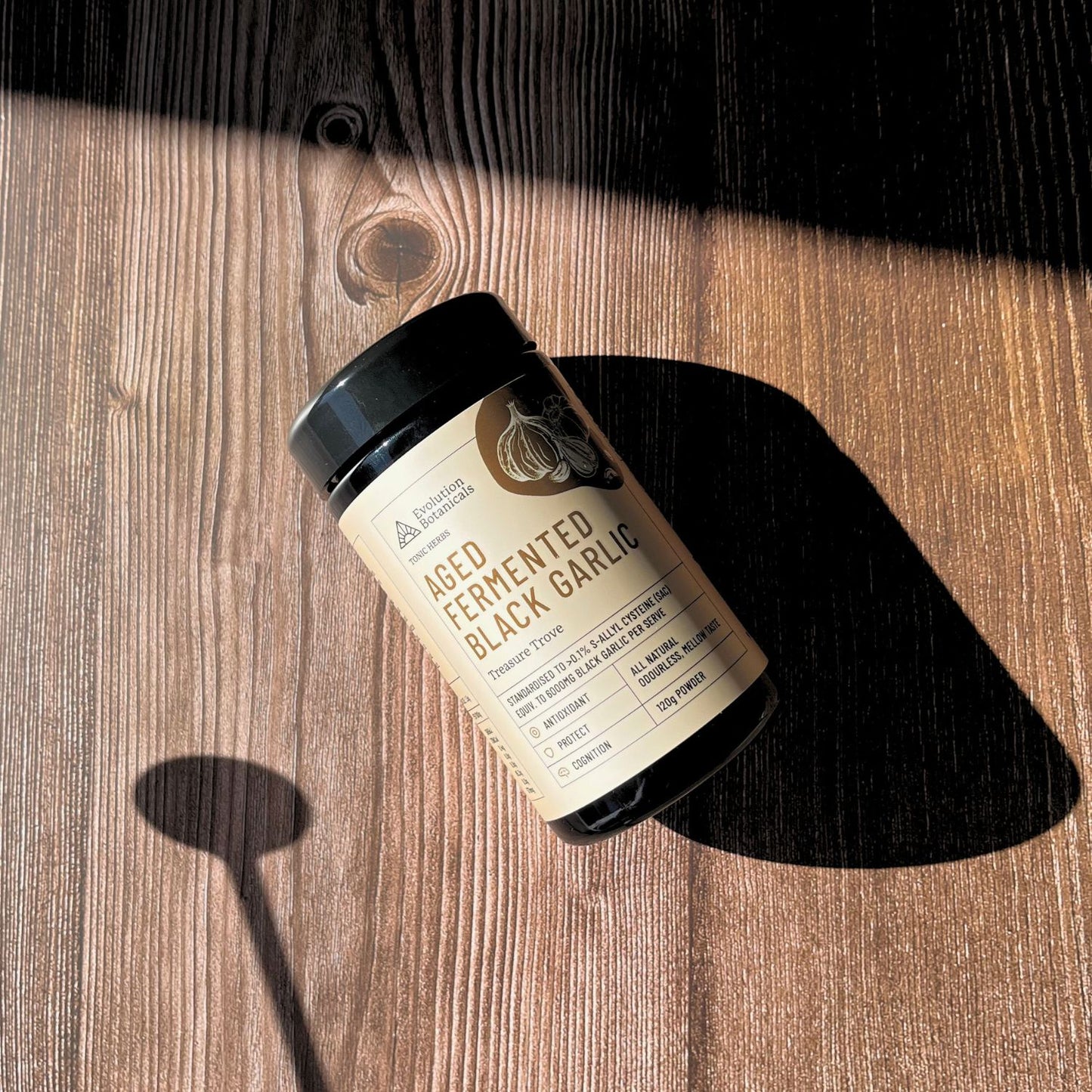 Black Garlic Wooden Background