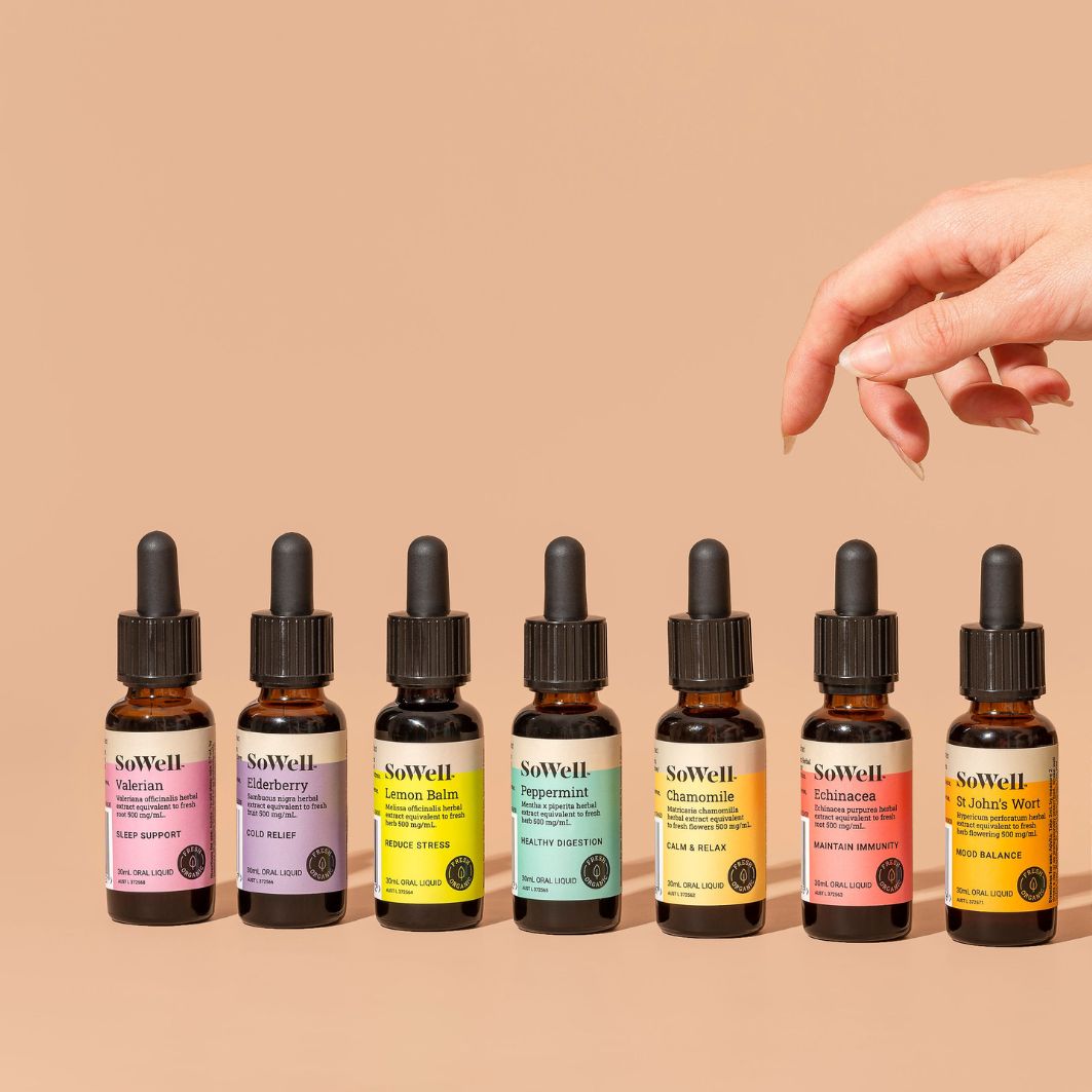 7 30ml dropper bottles of Sowell extracts on a skin toned background with a hand floating above them