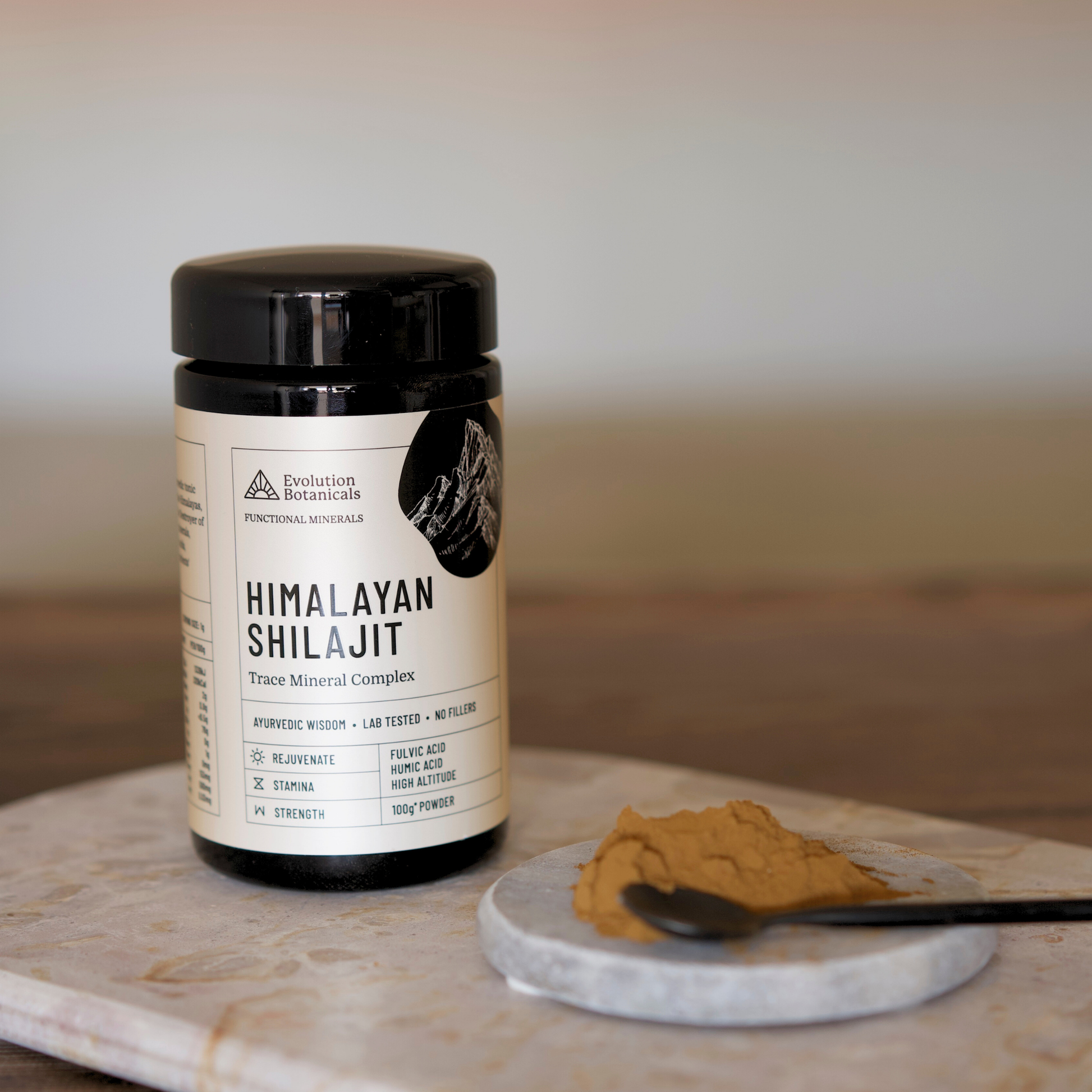 Evolution Botanicals Hima;ayan Shilajit on Bench with Powder on the side 