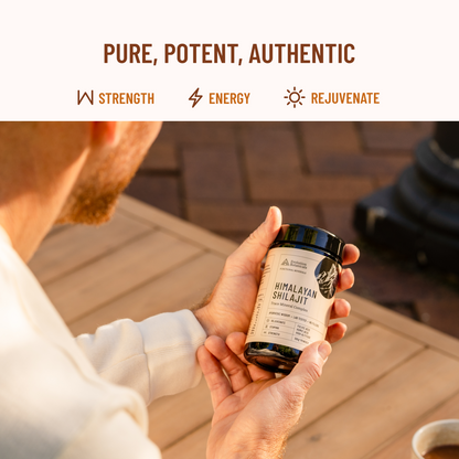 man holding jar of shilajit while sitting down 