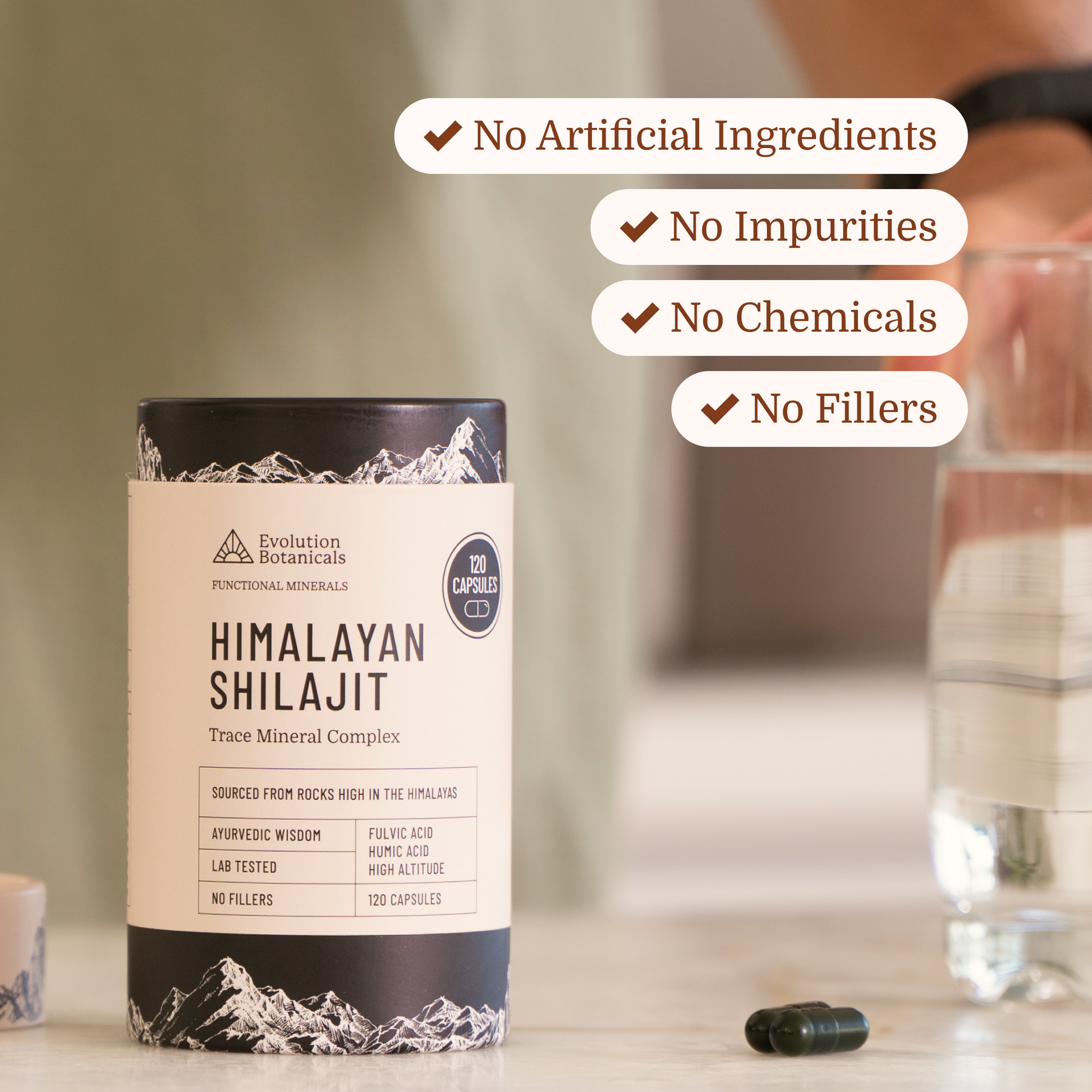 shilajit sitting on bench top with capsules next to it 