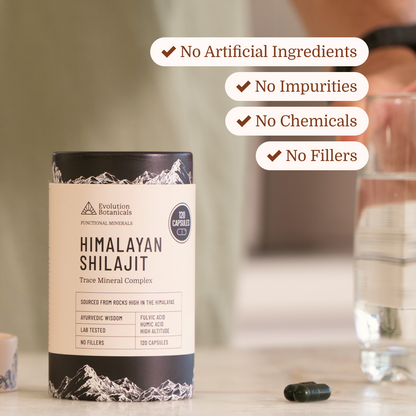 shilajit sitting on bench top with capsules next to it 